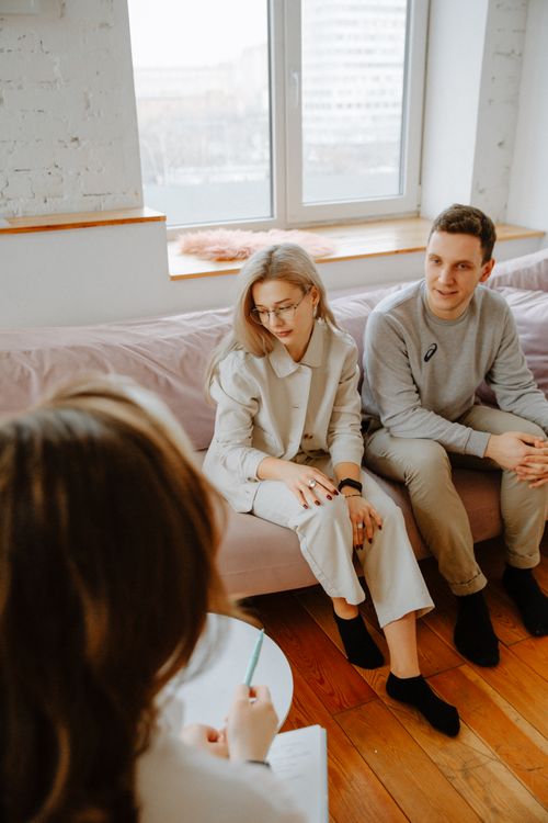 Couple in a counseling session with a therapist in a professional therapy office